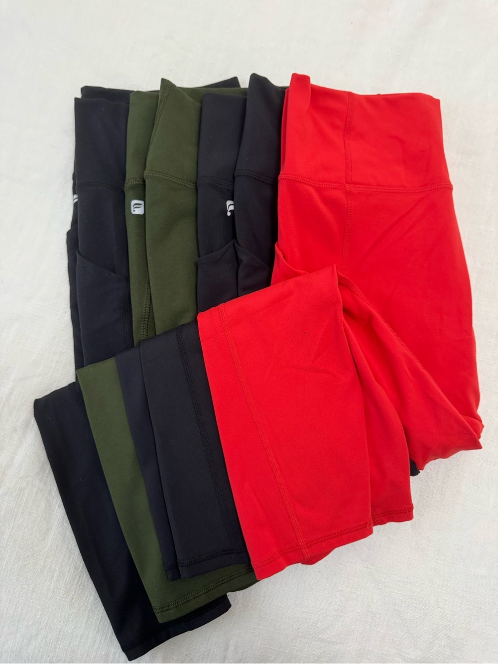 Fabletics Bundle of Four Women's Leggings in Red, Black, and Olive